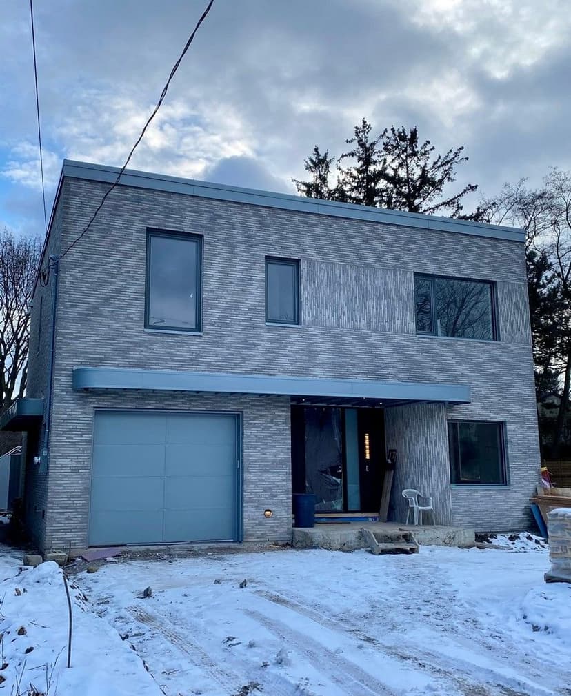 Zinc Hidden Garage Door and Fascia Cladding for Arceo Design Build