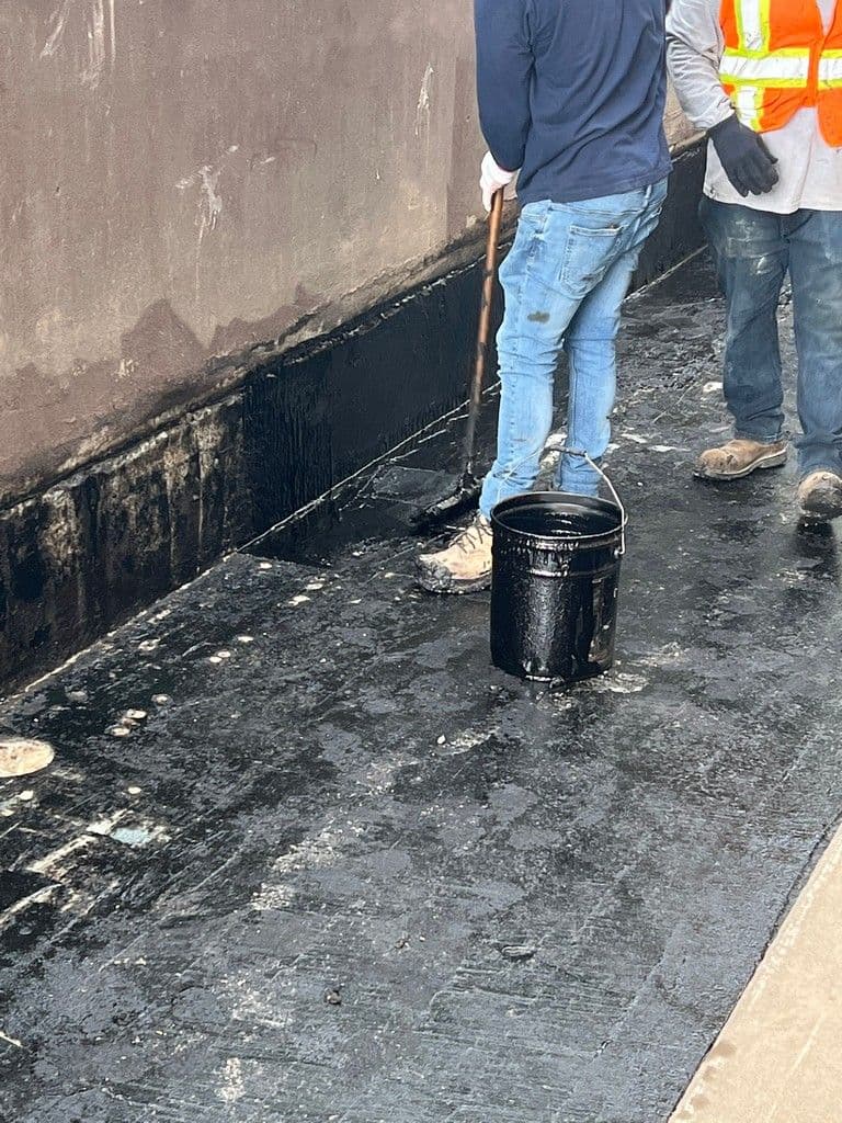 Waterproofing being applied from workers at Skyluxe Roofing